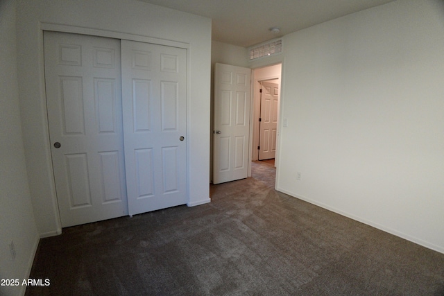 19841 W Cherry Lynn Rd W, Buckeye, AZ 85396 - unfurnished bedroom with dark colored carpet and a closet