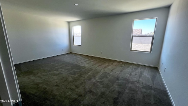 19841 W Cherry Lynn Rd W, Buckeye, AZ 85396 - spare room with dark carpet and baseboards