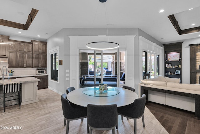 dining area with french doors, plenty of natural light, light hardwood / wood-style flooring, and sink