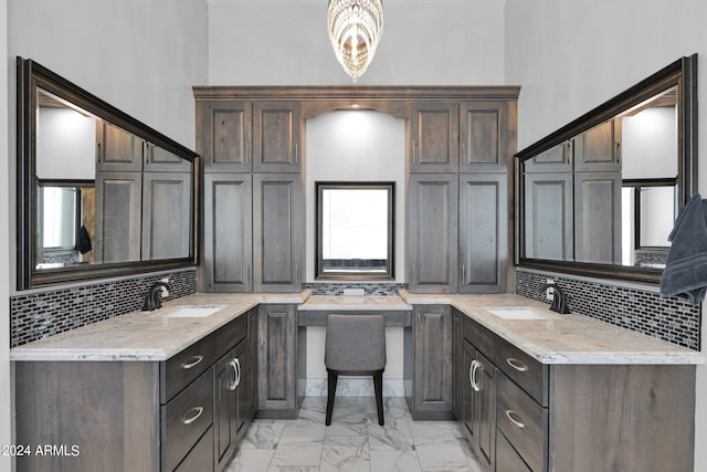 bathroom featuring vanity, a high ceiling, and decorative backsplash