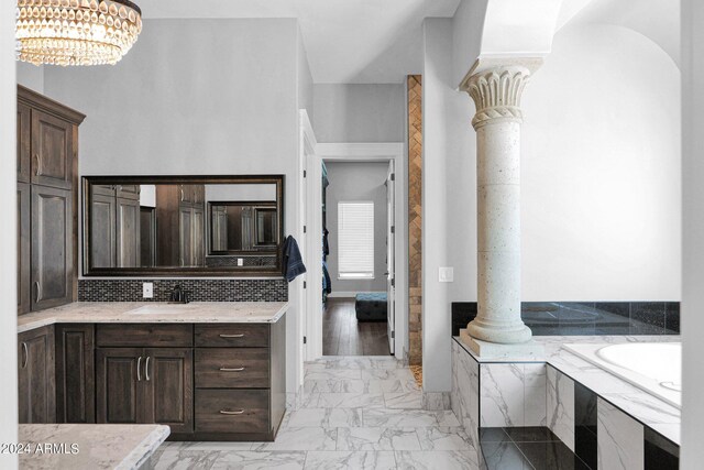 3749 E Juniper Cir, Mesa, AZ 85205 - bathroom with a chandelier, marble finish floor, vanity, decorative columns, and a tub to relax in