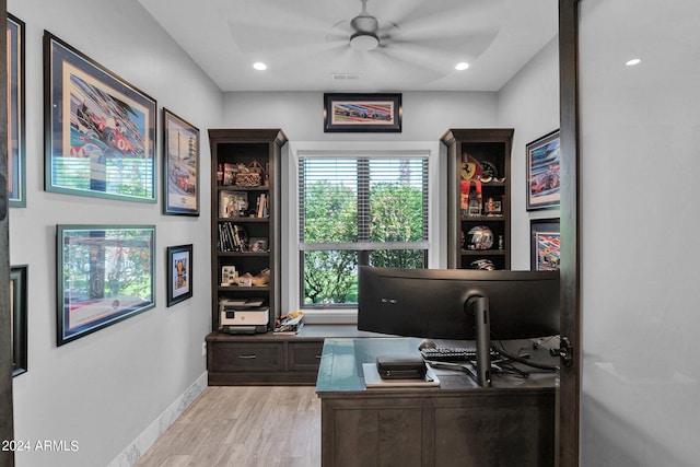 home office featuring light wood-type flooring and ceiling fan