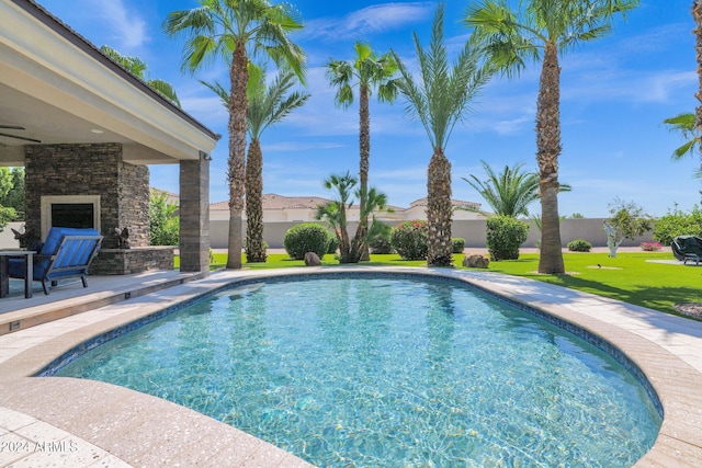 view of pool with a yard and a patio area