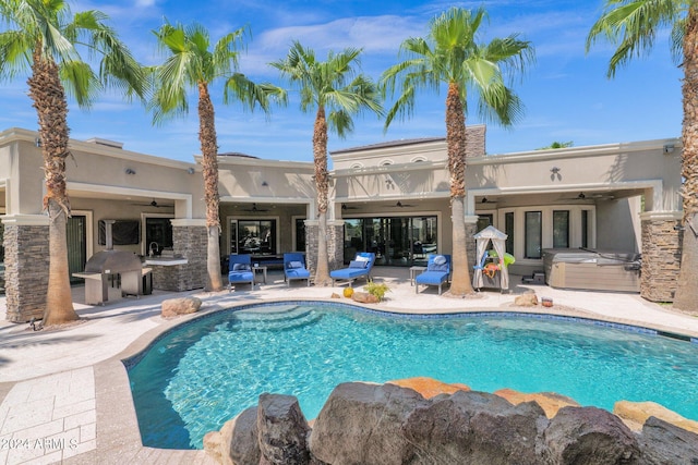 view of pool with exterior kitchen, ceiling fan, a patio area, and french doors