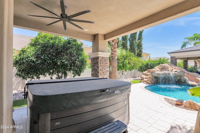 view of patio featuring pool water feature, ceiling fan, and a hot tub