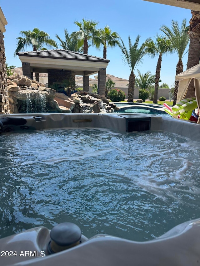 view of swimming pool featuring a hot tub