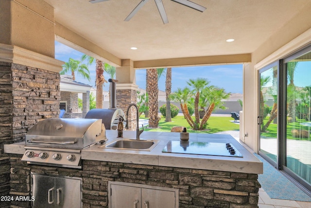 view of patio featuring exterior kitchen, grilling area, sink, and ceiling fan