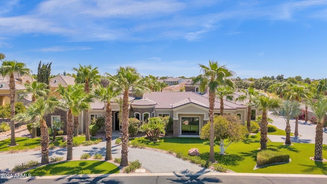 mediterranean / spanish-style house featuring a front lawn