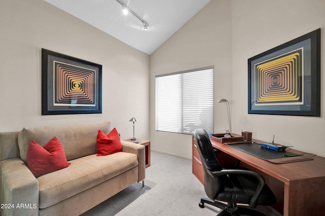 carpeted office space featuring rail lighting and lofted ceiling