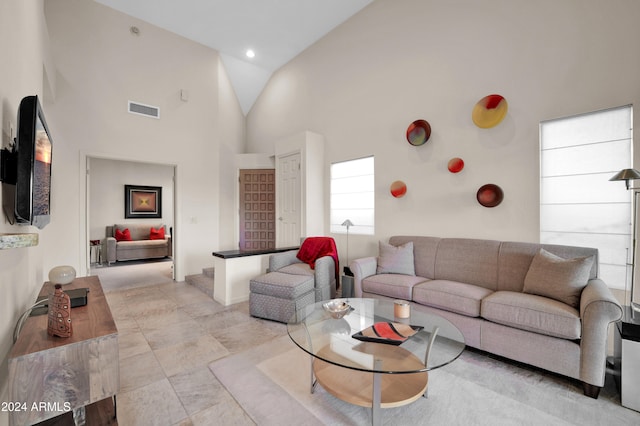 living room featuring high vaulted ceiling