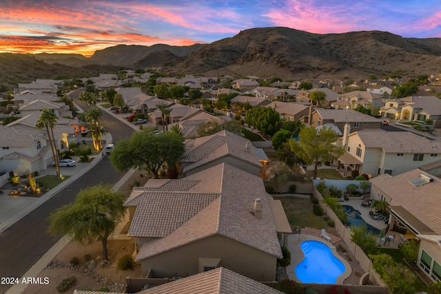 aerial view at dusk featuring a mountain view