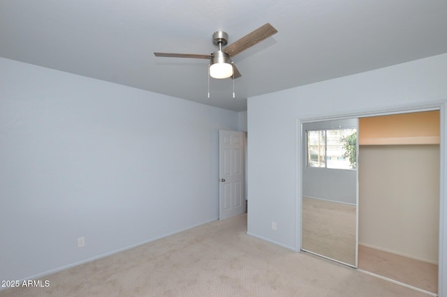 unfurnished bedroom with light colored carpet, ceiling fan, and a closet