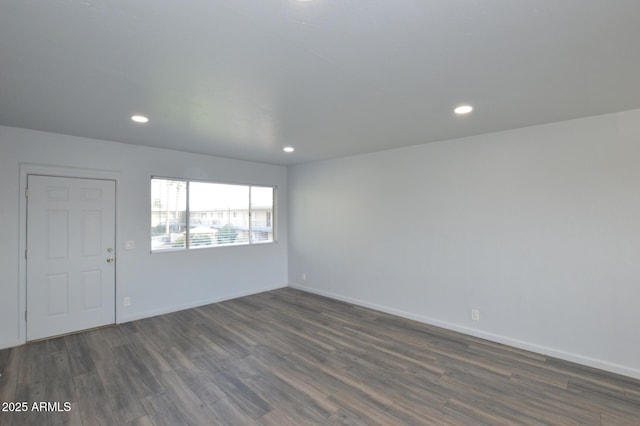 empty room with dark wood-type flooring