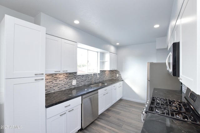 kitchen with tasteful backsplash, stainless steel appliances, sink, and white cabinets