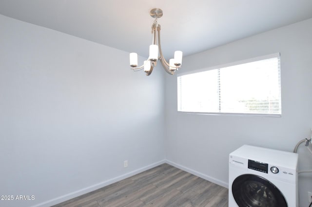 laundry room with an inviting chandelier, washer / clothes dryer, and dark hardwood / wood-style floors