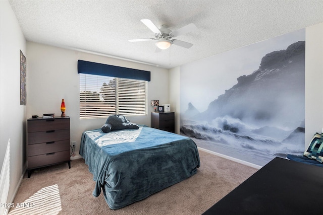 carpeted bedroom with ceiling fan and a textured ceiling