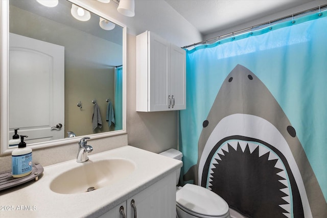 bathroom with vanity, toilet, and curtained shower