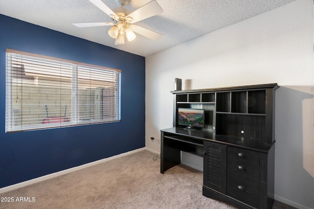 carpeted office space with a textured ceiling and ceiling fan