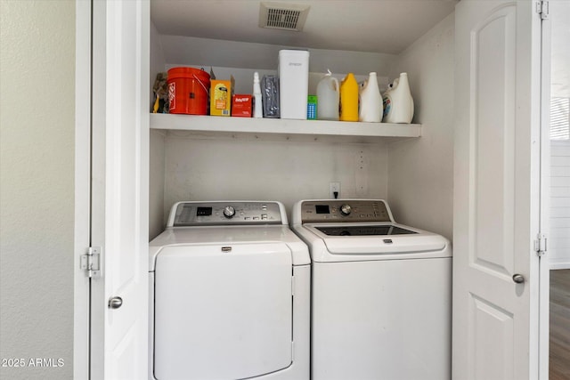 clothes washing area featuring washer and dryer