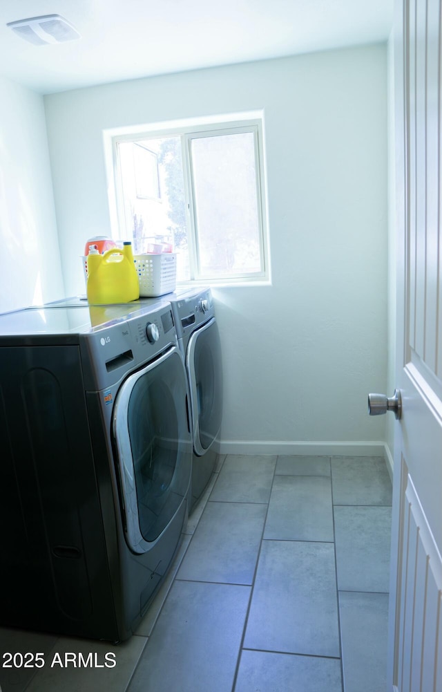 washroom featuring laundry area, tile patterned flooring, baseboards, and washer and dryer