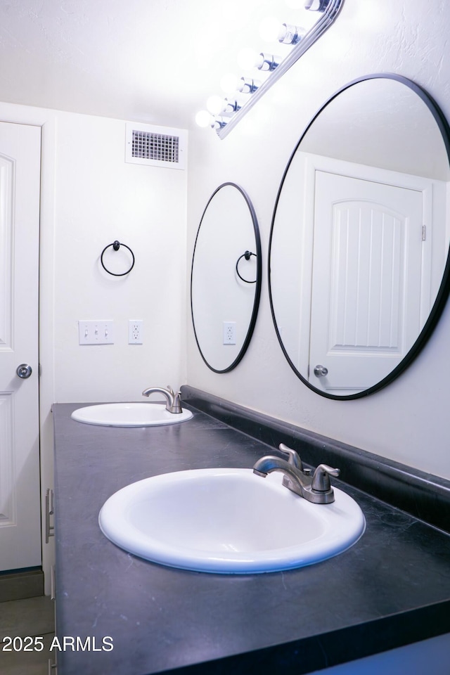 bathroom featuring a sink and visible vents