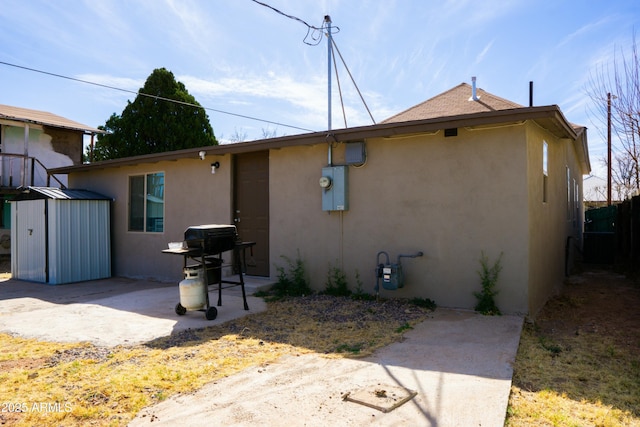 back of house with a patio and stucco siding