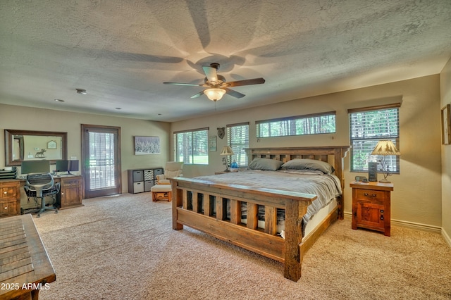 bedroom with light colored carpet, a textured ceiling, baseboards, and multiple windows