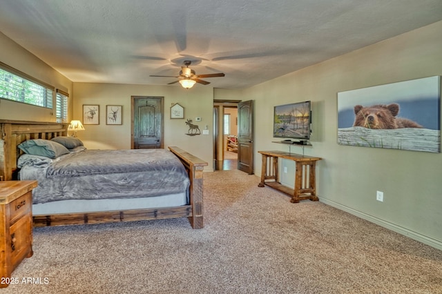 carpeted bedroom featuring a textured ceiling, a ceiling fan, and baseboards