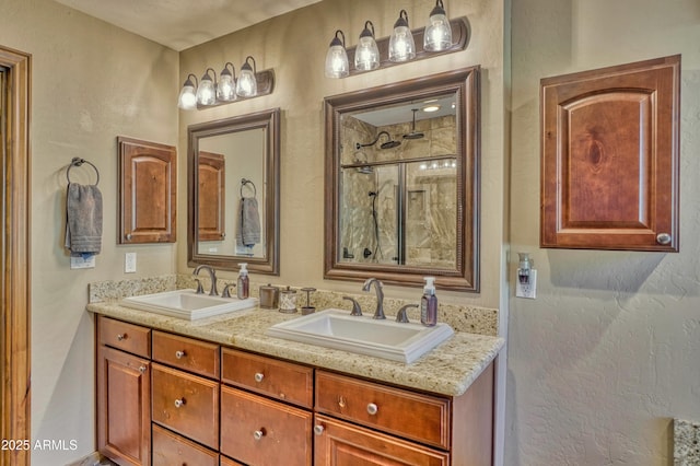 bathroom featuring double vanity, a shower, and a sink