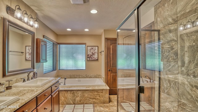 full bathroom with a bath, a stall shower, double vanity, and a sink