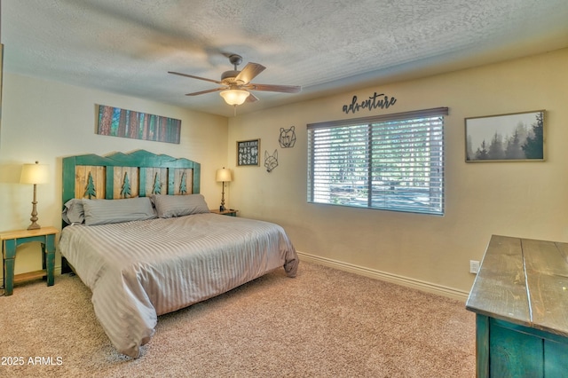 carpeted bedroom with a textured ceiling, ceiling fan, and baseboards