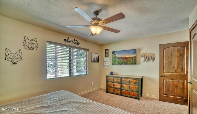 bedroom with a textured ceiling, carpet, and baseboards