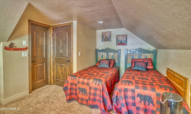 bedroom with a textured ceiling, a textured wall, and carpet