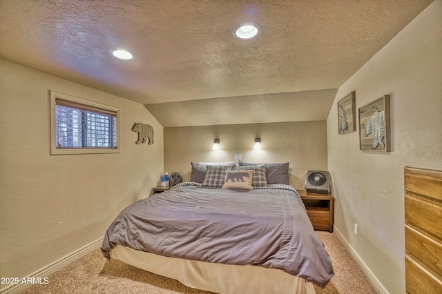 carpeted bedroom featuring baseboards, vaulted ceiling, a textured ceiling, and a textured wall