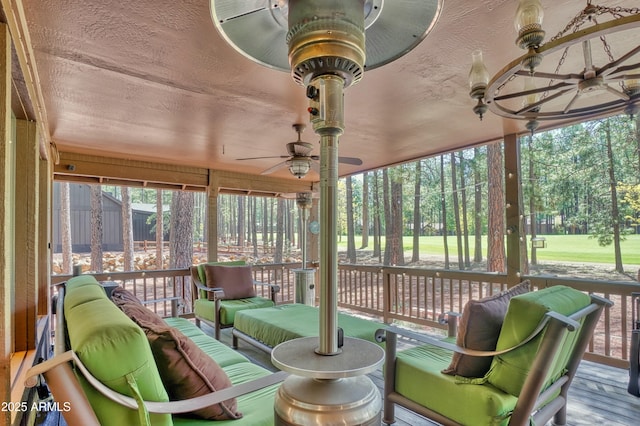 sunroom / solarium featuring ceiling fan