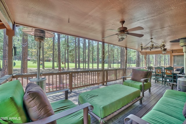 sunroom featuring a ceiling fan