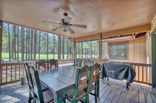 sunroom featuring ceiling fan