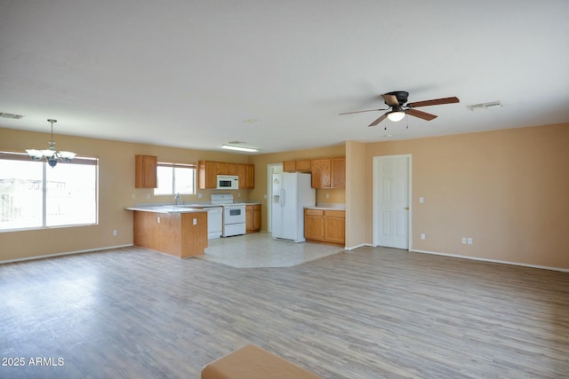 kitchen featuring white appliances, visible vents, open floor plan, light countertops, and light wood finished floors