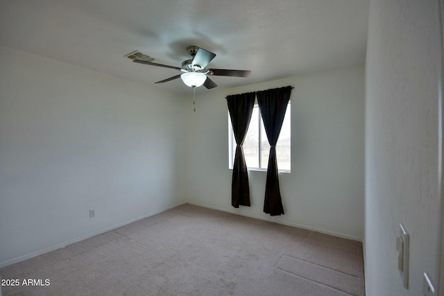 unfurnished room with a ceiling fan, carpet flooring, visible vents, and baseboards