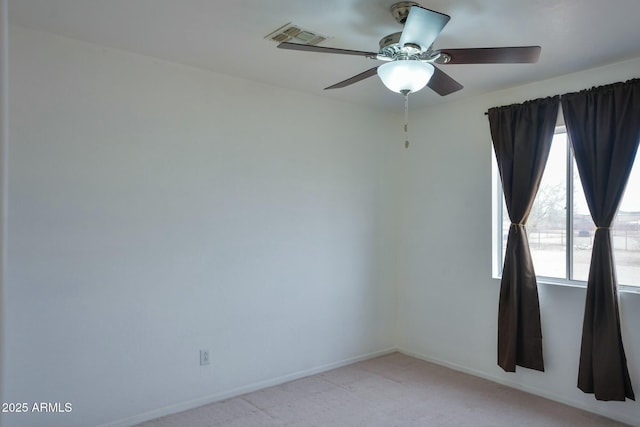 empty room featuring light carpet, baseboards, visible vents, and a wealth of natural light