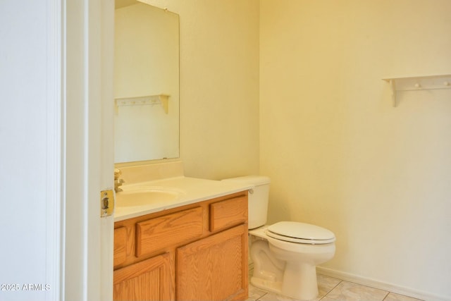 bathroom with tile patterned flooring, vanity, and toilet