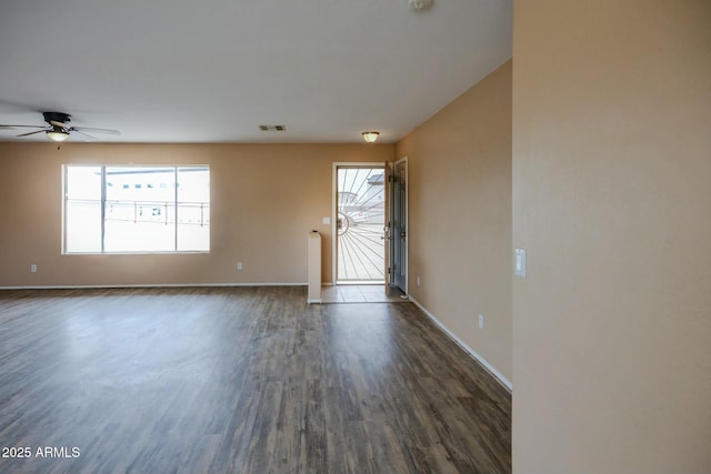 entrance foyer featuring dark wood-style flooring, visible vents, ceiling fan, and baseboards