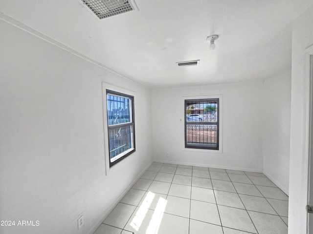 unfurnished room featuring light tile patterned floors