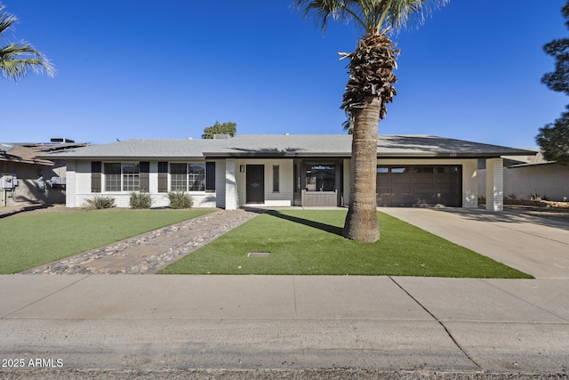 ranch-style house featuring a front yard and a garage