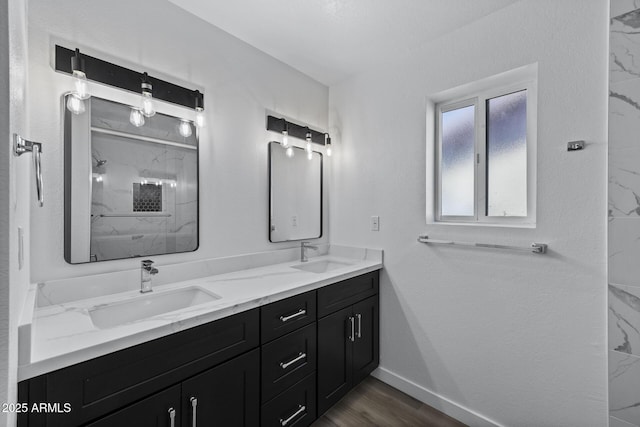 bathroom with a shower, hardwood / wood-style floors, and vanity