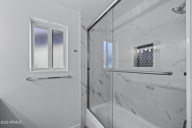 bathroom with shower / bath combination with glass door