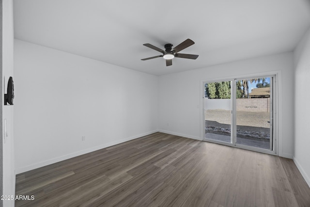 spare room featuring ceiling fan and dark hardwood / wood-style flooring