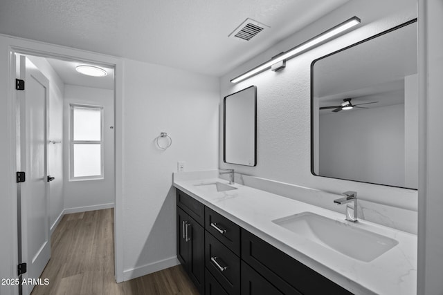 bathroom with vanity, a textured ceiling, and hardwood / wood-style floors