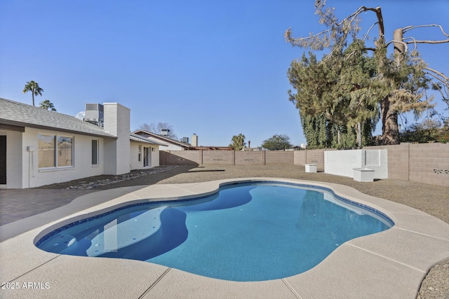 view of swimming pool with central air condition unit and a patio area