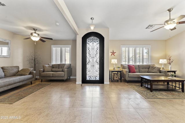 foyer entrance with a ceiling fan and healthy amount of natural light